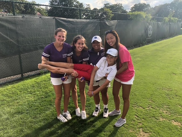 Group of five players on the grass court at West Side Tennis Club