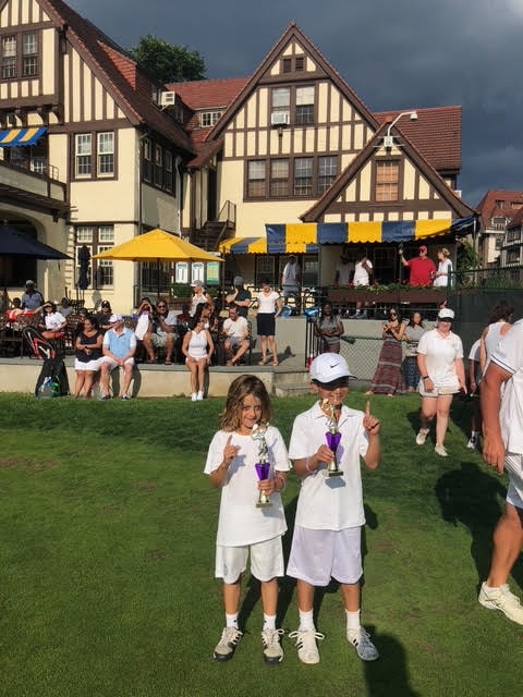 Kids with trophies at West Side Tennis Club clubhouse